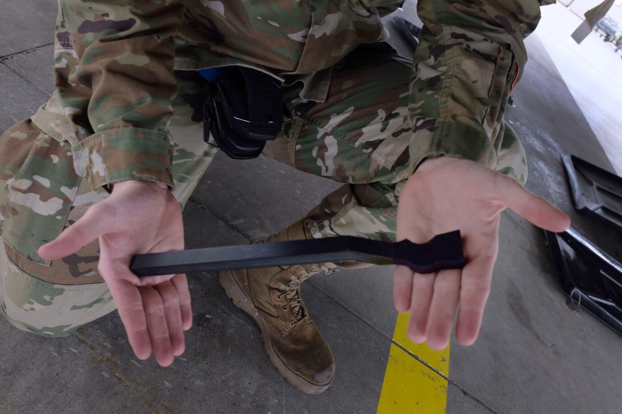 Air Force Airman 1srt Class Andrew Mathews, 3rd Aircraft Maintenance Squadron weapons load crew member, use a spanner wrench to lock an LAU-142/A Advanced Medium-Range Air-to-Air Missile Vertical Ejection Launcher on an F-22 Raptor at Joint Base Elmendorf-Richardson, Alaska, May 5, 2021. Mathews helped fabricate the spanner wrench, saving auxiliary power unit run time, wear, and tear.