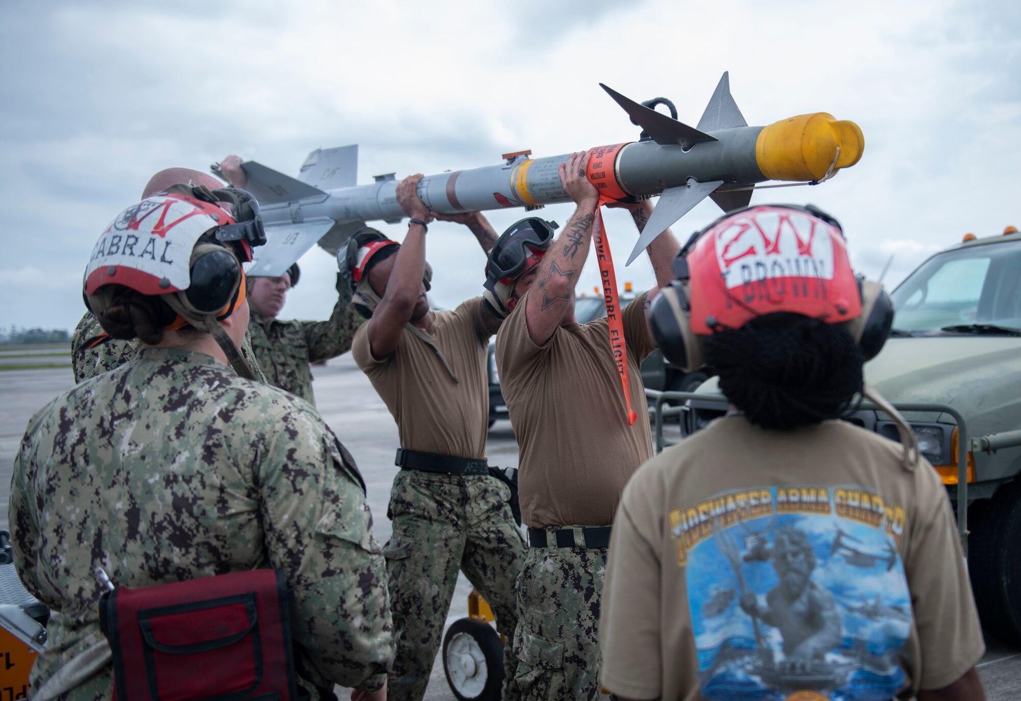 Men hold a missile over their heads