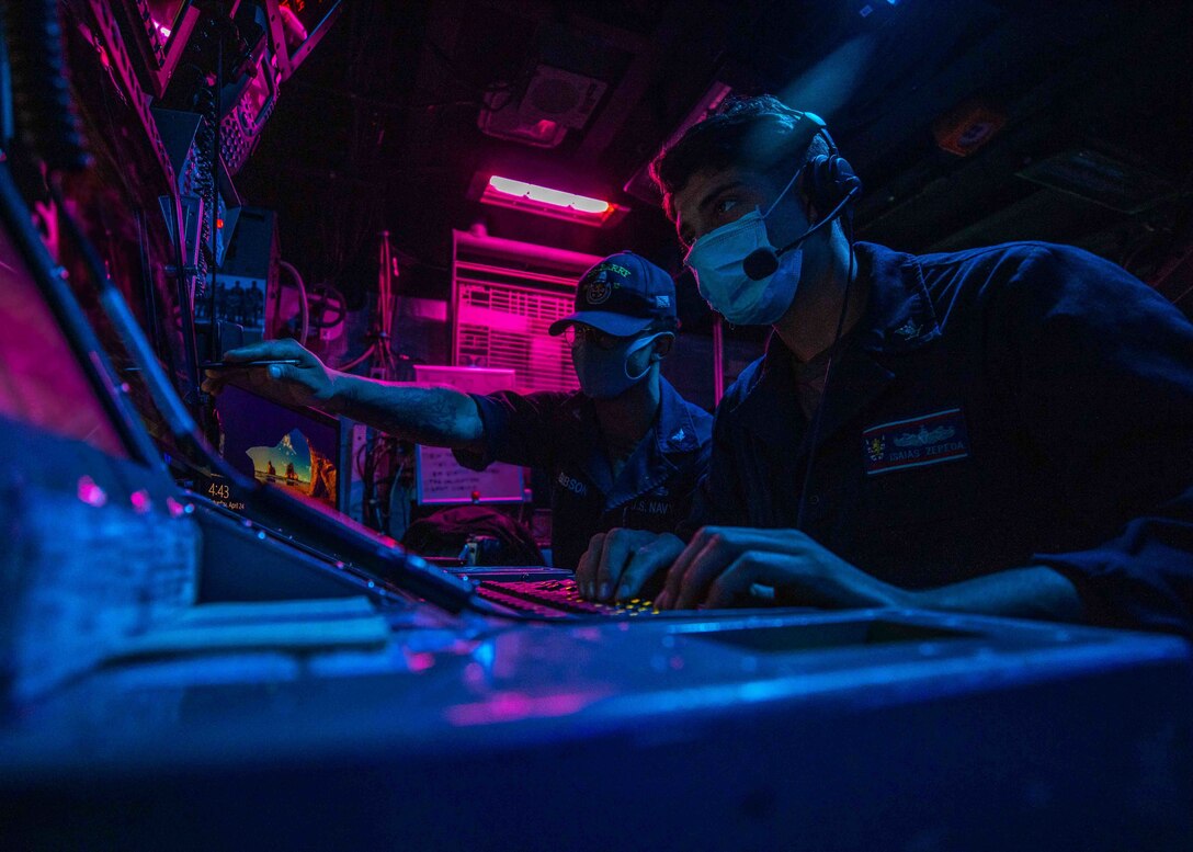 Cryptologic Technical Technician 2nd Class Brandon Gibson, from Sacramento, Calif. and Cryptologic Technical Technician 3rd Class Isais Zepeda, from Anthony, N.M., stand the Electronic Warfare Supervisor watch.