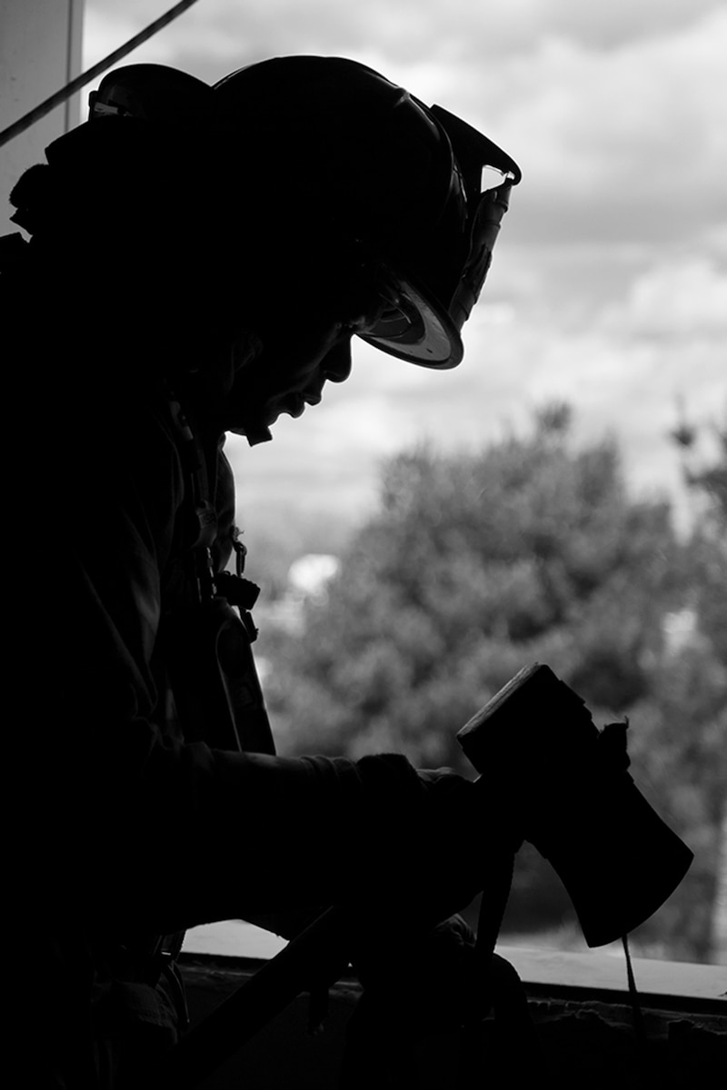 Anthony Jimcoily, a firefighter from Arnold Air Force Base, Tenn., wraps a safety line around his axe to use as a safety line before he egresses from a second story wind at Grissom’s fire training facility. Firefighters from six different departments trained here May 10-14, 2021. (Air Force photo by Douglas Hays)