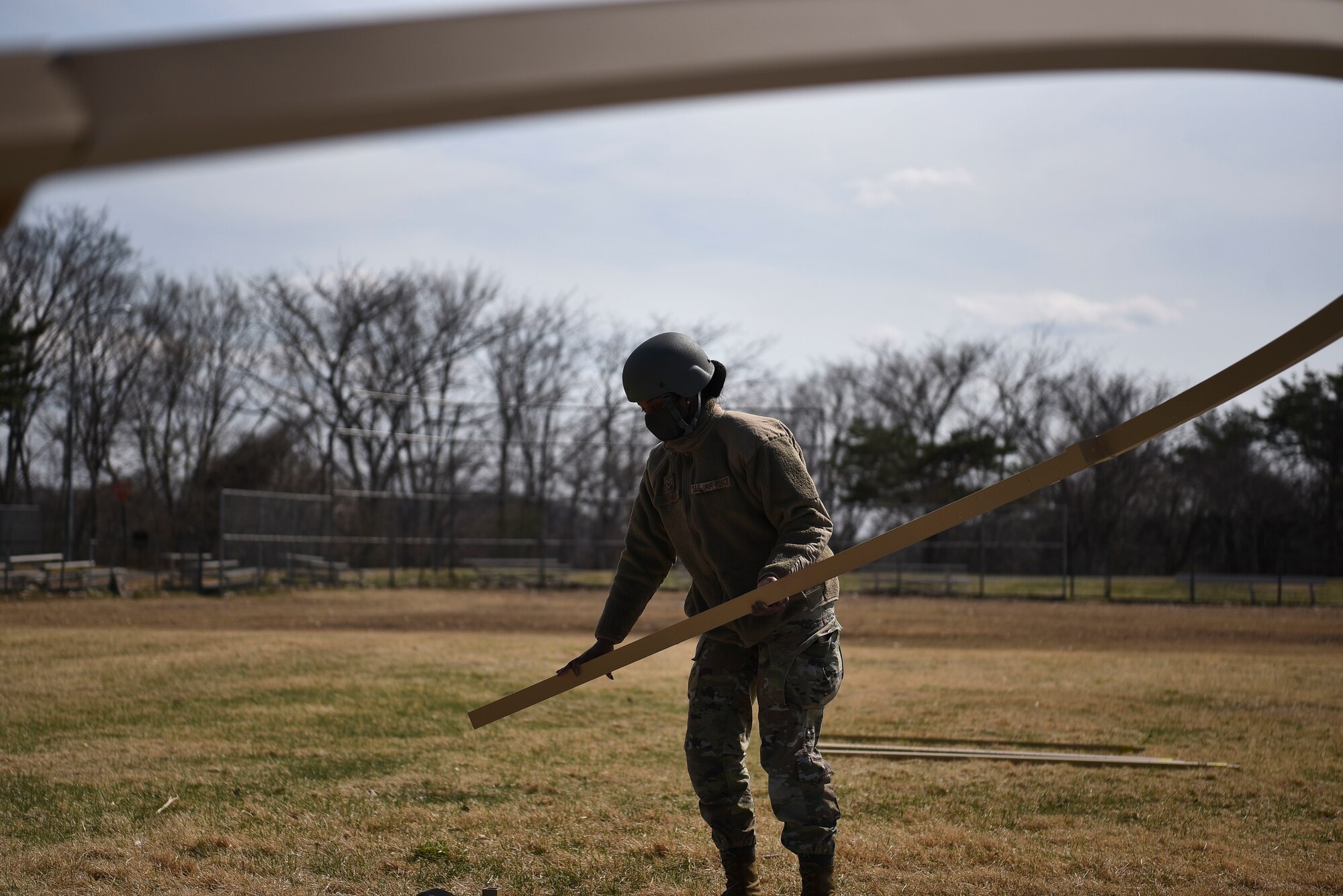 U.S. Air Force Senior Airman Kealani Gaspard, a 35th Operations Support Squadron intelligence analyst, carries a Small Shelter System roof beam to its designated spot during Agile Combat Employment training at Misawa Air Base, Japan, April 8, 2021.