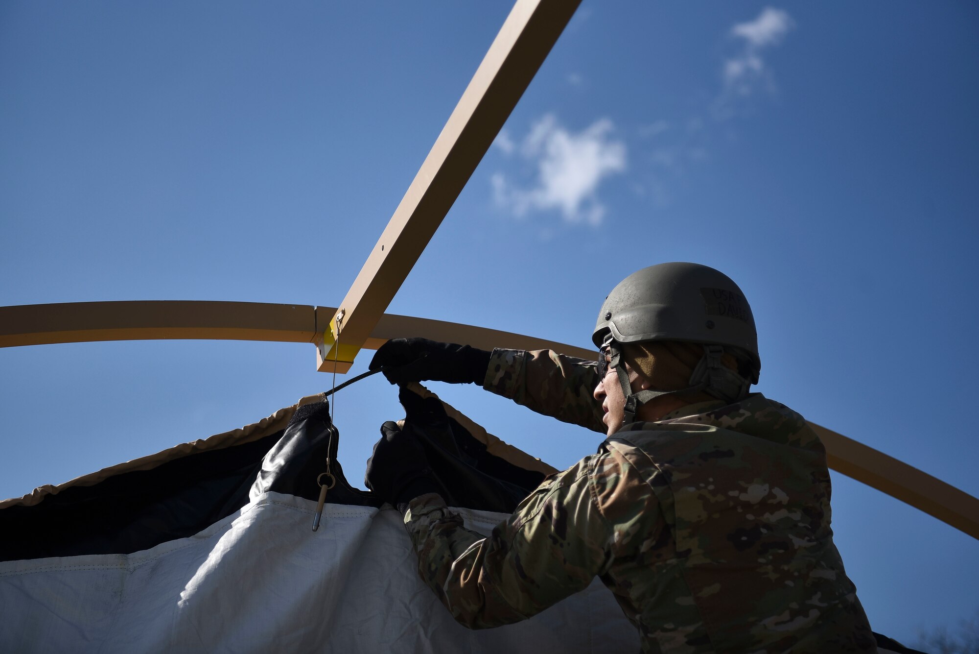 U.S. Air Force Airman 1st Class Davis Angel, a 35th Operations Support Squadron aircrew flight equipment technician, assembles a Small Shelter System during Agile Combat Employment training at Misawa Air Base, Japan, April 8, 2021.