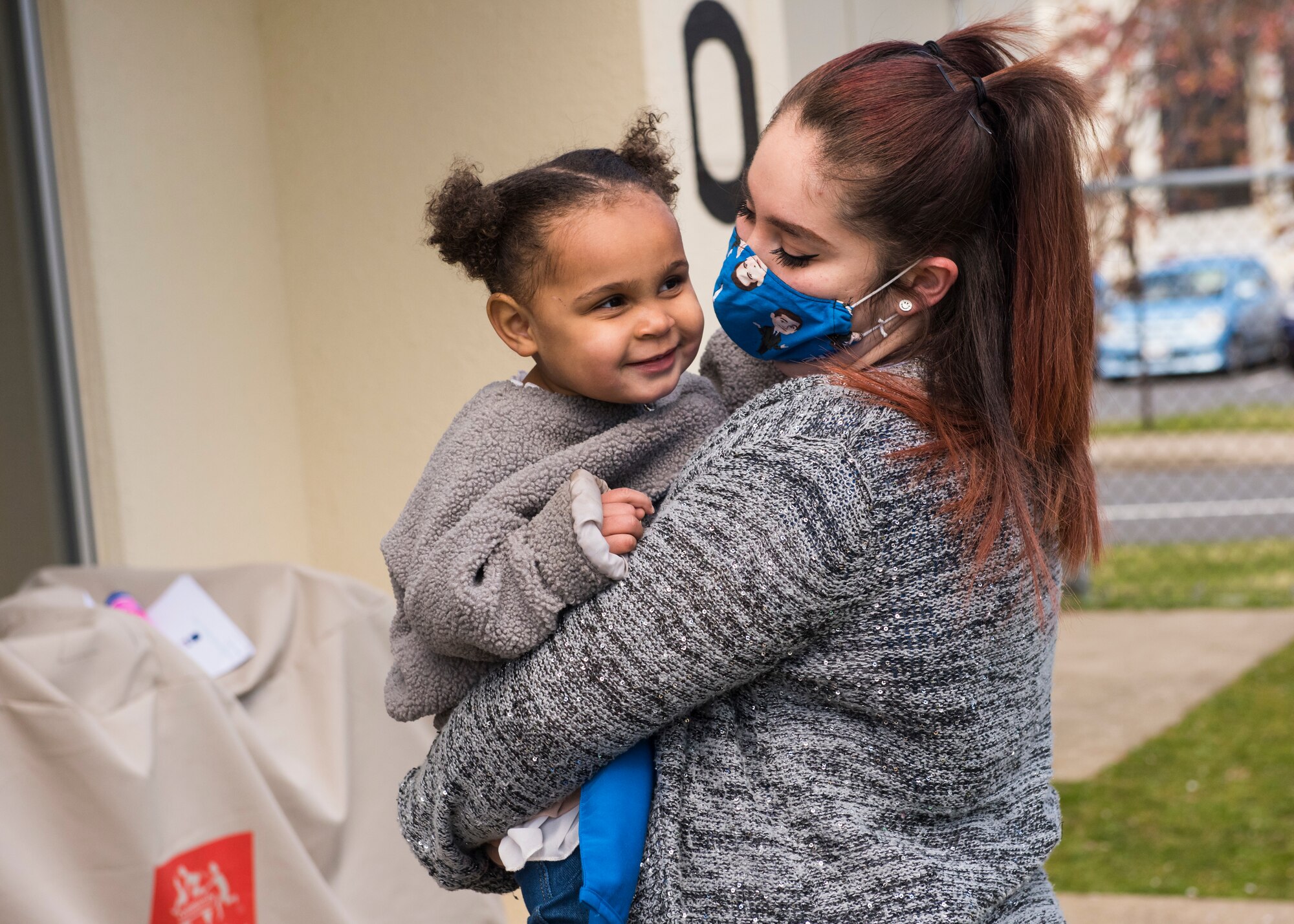 A Yoiko Child Development Center teacher holds a student during a class break at Misawa Air Base, Japan, April 26, 2021.