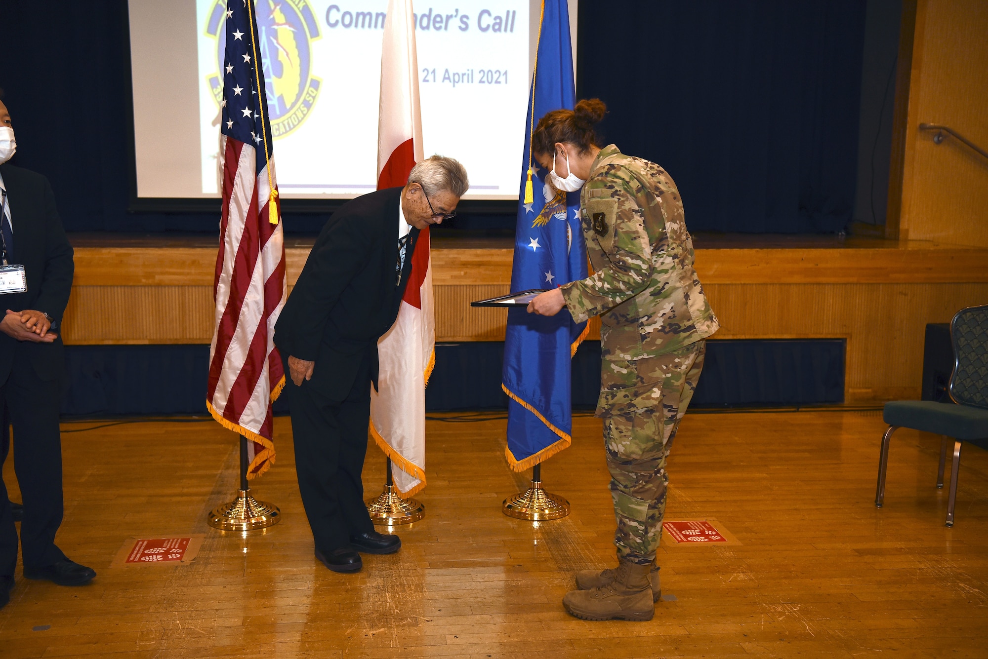 U.S. Air Force Senior Airman Hannah Tatum, 35th Communication Squadron radio frequency transmission systems technician, accepts a letter of appreciation from City of Misawa Social Welfare President, Shinji Kuroda, during an all-call at Misawa Air Base, April 21, 2021.