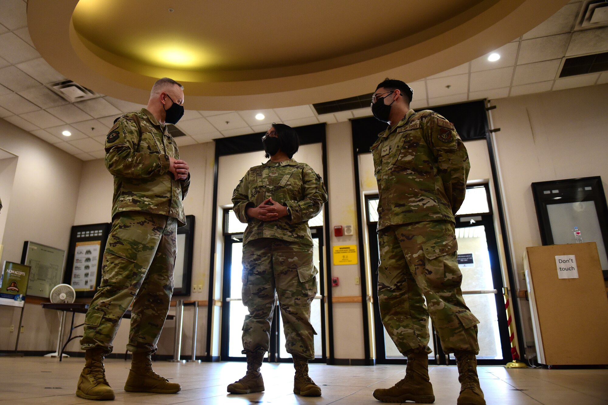 Chief Master Sgt. Phil Hudson, 7th Air Force command chief, speaks with Tech. Sgt. Elizabeth  Batan, 8th Communications Squadron knowledge management section chief, and Senior Airman Matthew Rodriguez, 8th CS client systems technician, inside the base theater during a 7th AF leadership visit at Kunsan Air Base, Republic of Korea, May 12, 2021. During the visit, Hudson toured many units around base, coined outstanding Airmen and held multiple mentorship sessions. (U.S. Air Force photo by Senior Airman Suzie Plotnikov)