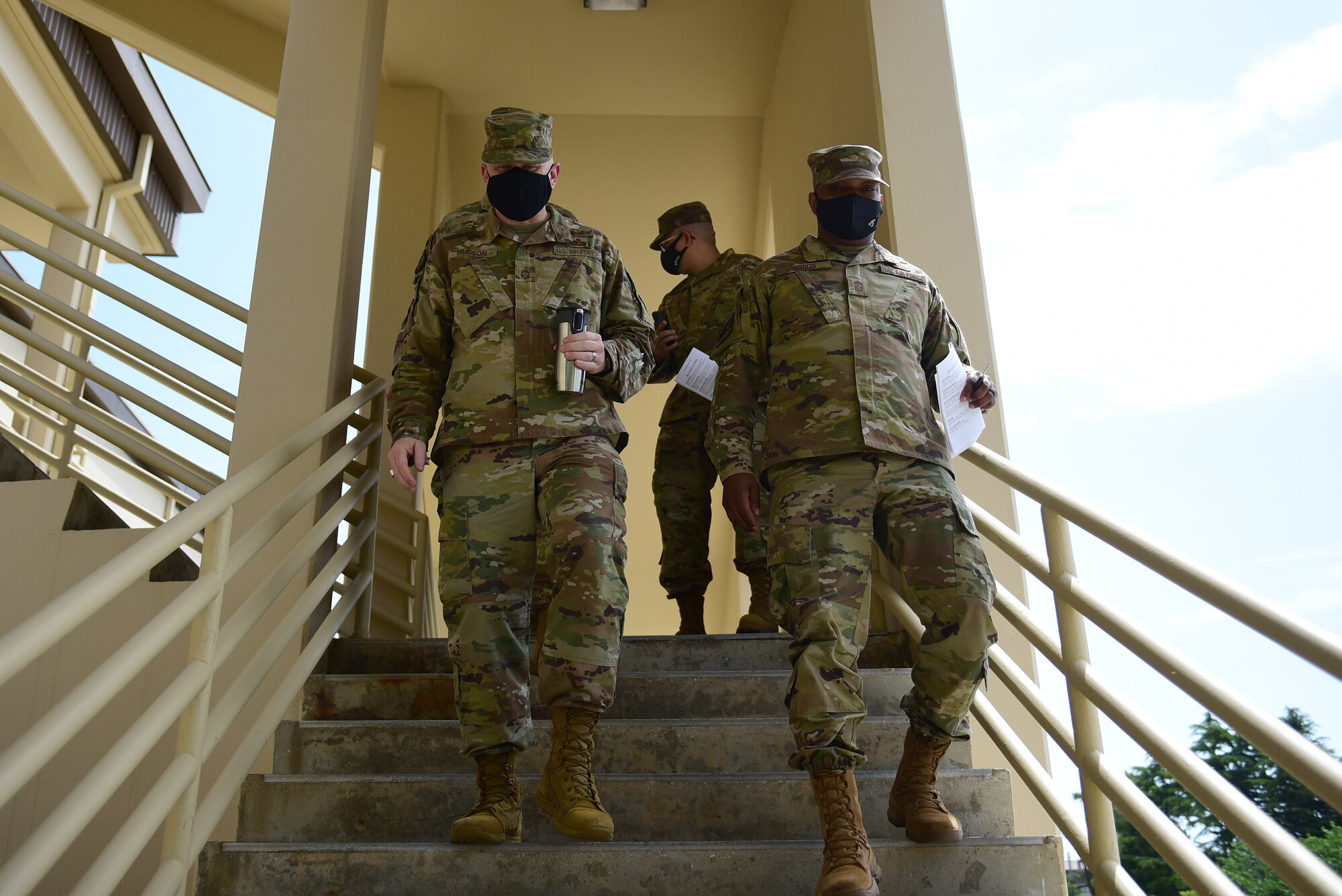 Chief Master Sgt. Phil Hudson, 7th Air Force command chief, and Chief Master Sgt. Ronnie “Wolf Chief” Woods, 8th Fighter Wing command chief, walk down the 8th FW headquarters building stairs at Kunsan Air Base, Republic of Korea, May 12, 2021. During the visit, Hudson toured many units around base, coined outstanding Airmen and held multiple mentorship sessions. (U.S. Air Force photo by Senior Airman Suzie Plotnikov)