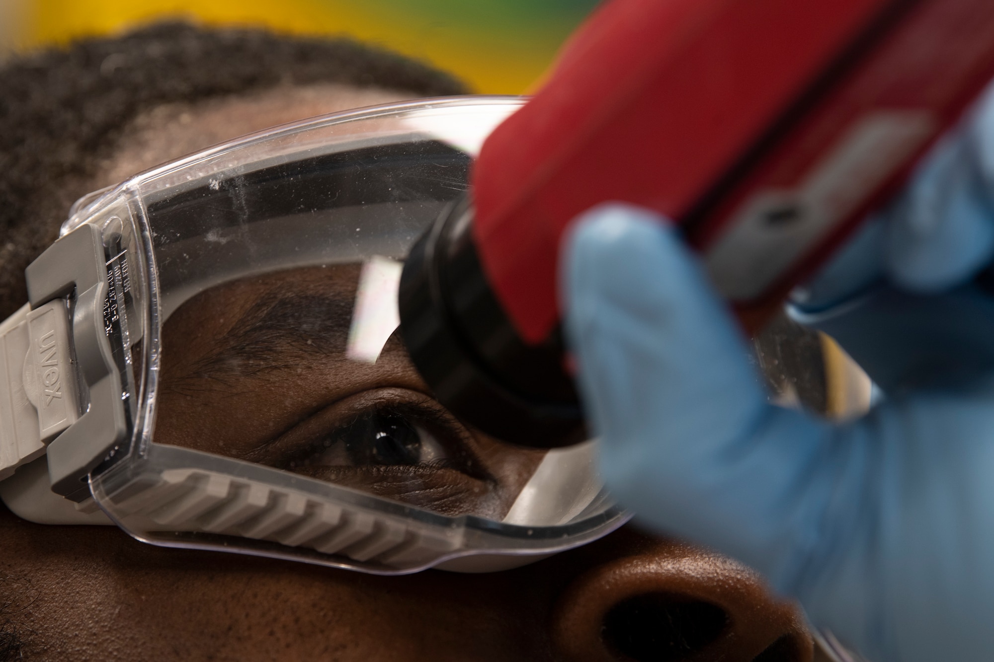 U.S. Air Force Airman inspects a fuel sample.