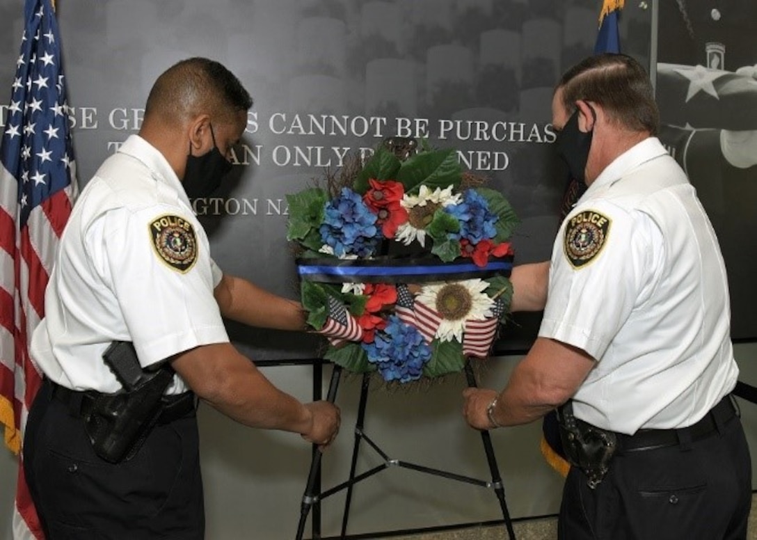 Yesterday, in honor of National Police week and in remembrance of fallen law enforcement officers, DIA Police Chief Andre Tibbs (left) and Deputy Chief John Richter (right) place a wreath at DIA Headquarters. (Photo by Dave Richards, OCC)