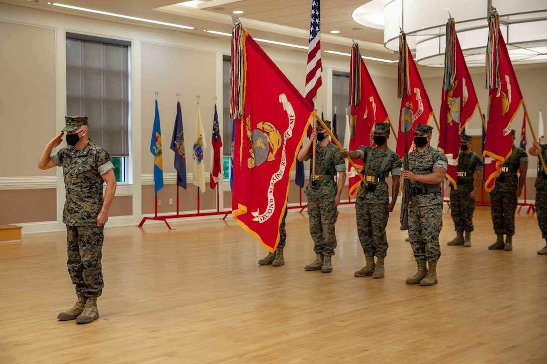 U.S. Marines with a 2d Marine Division color guard stand at attention during a change of command ceremony on Camp Lejeune, N.C., May 12, 2021.