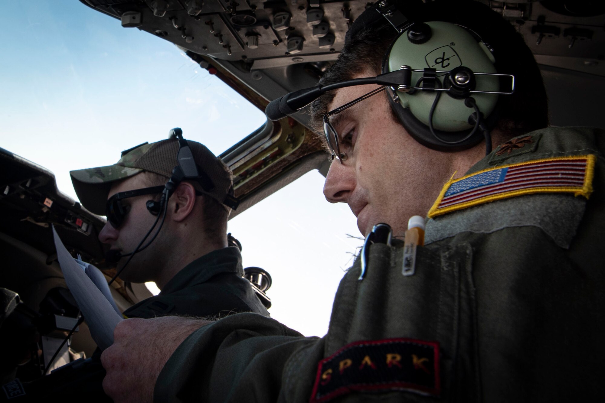 Photo of an Airman reading air refueling checklist during Swift Response 21.