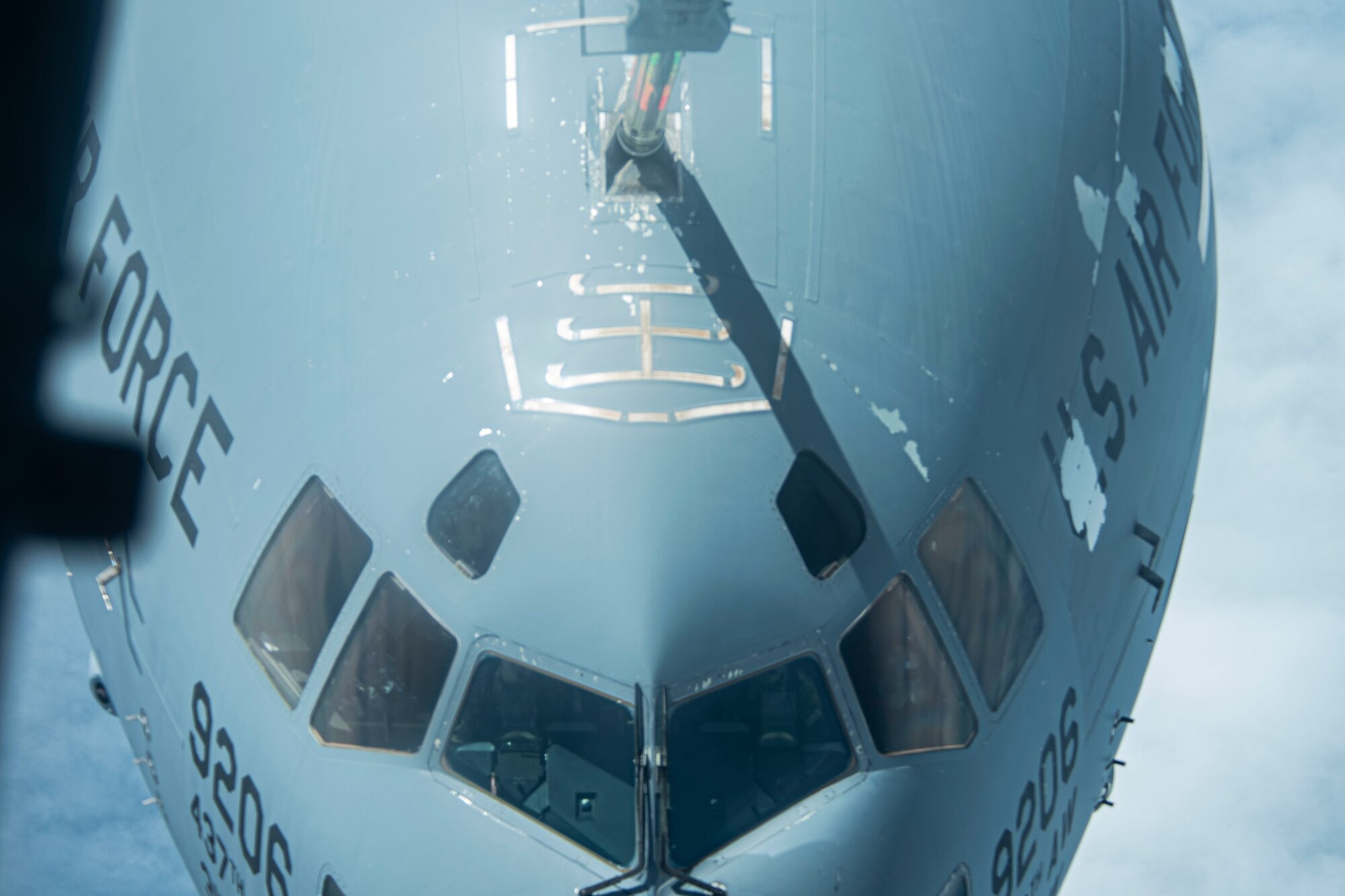 Photo of a U.S. Air Force C-17 Globemaster III assigned to Joint Base Charleston, S.C., moving into position for in-flight refueling from a KC-10 Extender.