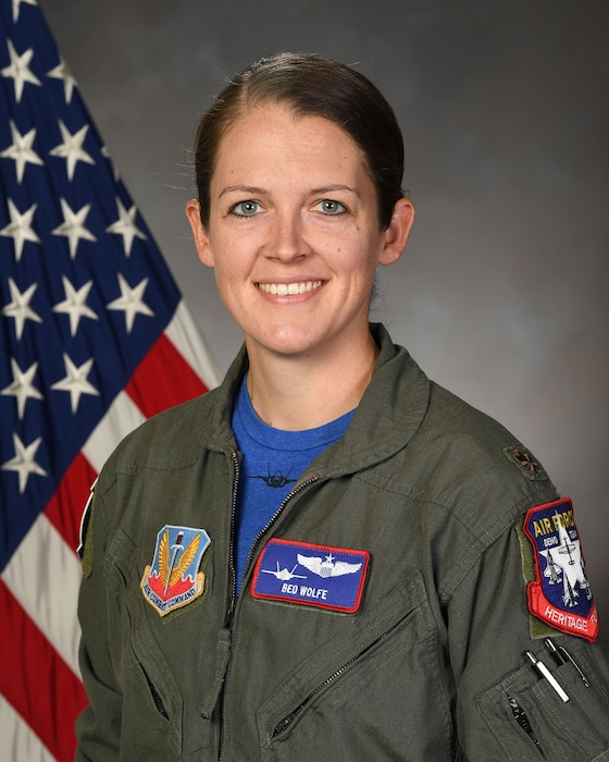 A biographical headshot of Maj. Kristin Wolfe, Air Force pilot