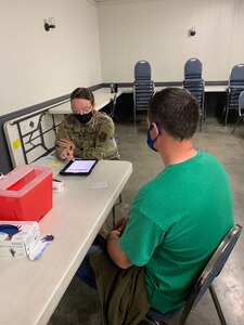 Airman 1st Class Krysta Waitl, who is assigned to the 139th Force Support Squadron’s services flight, Missouri Air National Guard, assists a citizen at a vaccination site in Northeast Missouri, April 7, 2021.