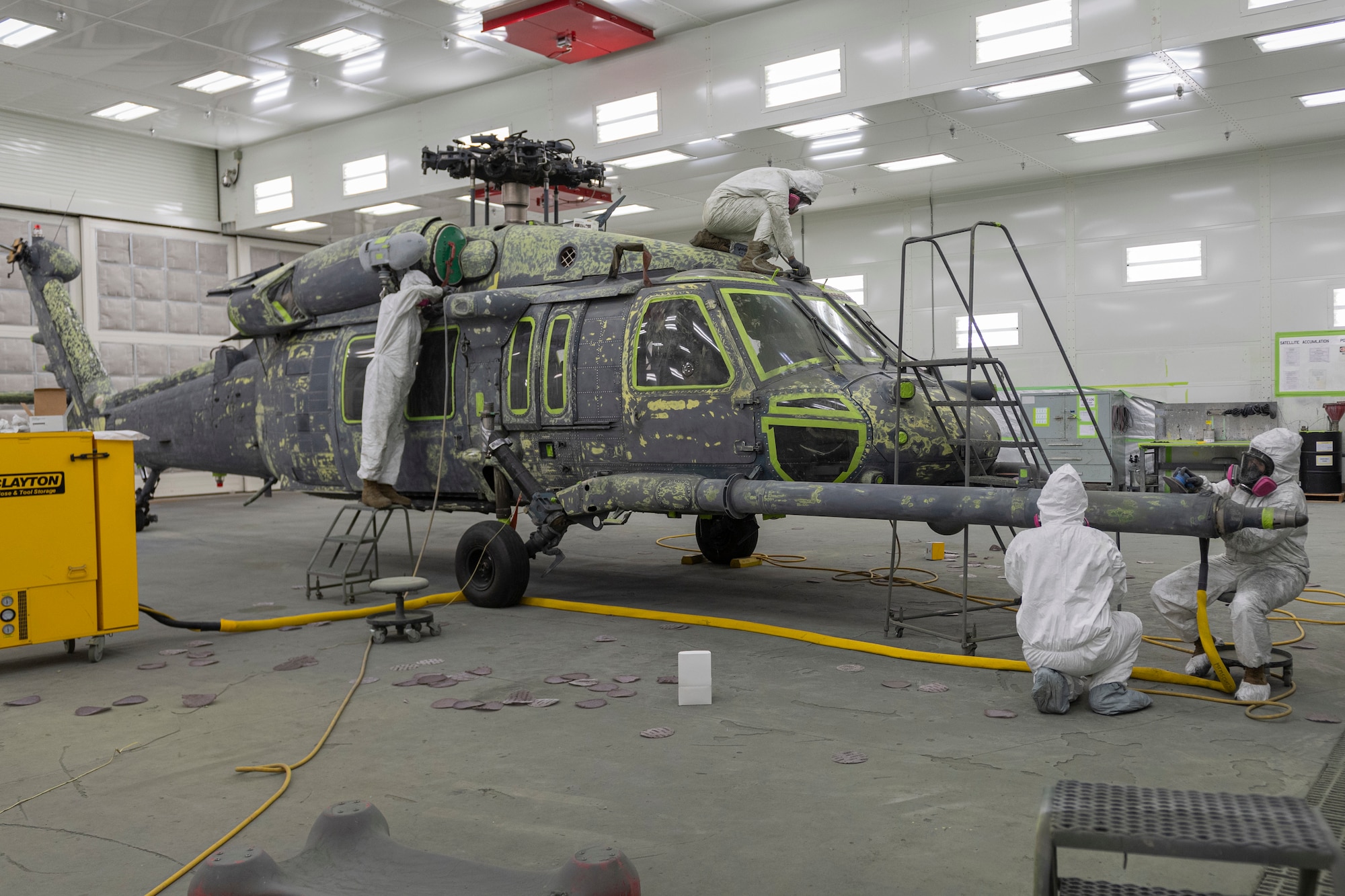 Photo of Airmen preparing a helicopter for masking