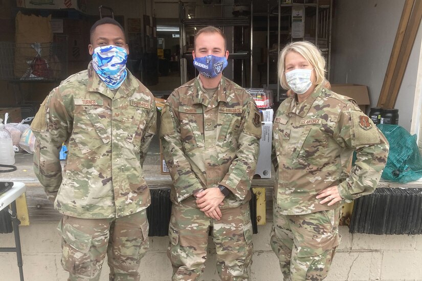Three airmen pose for a photo.