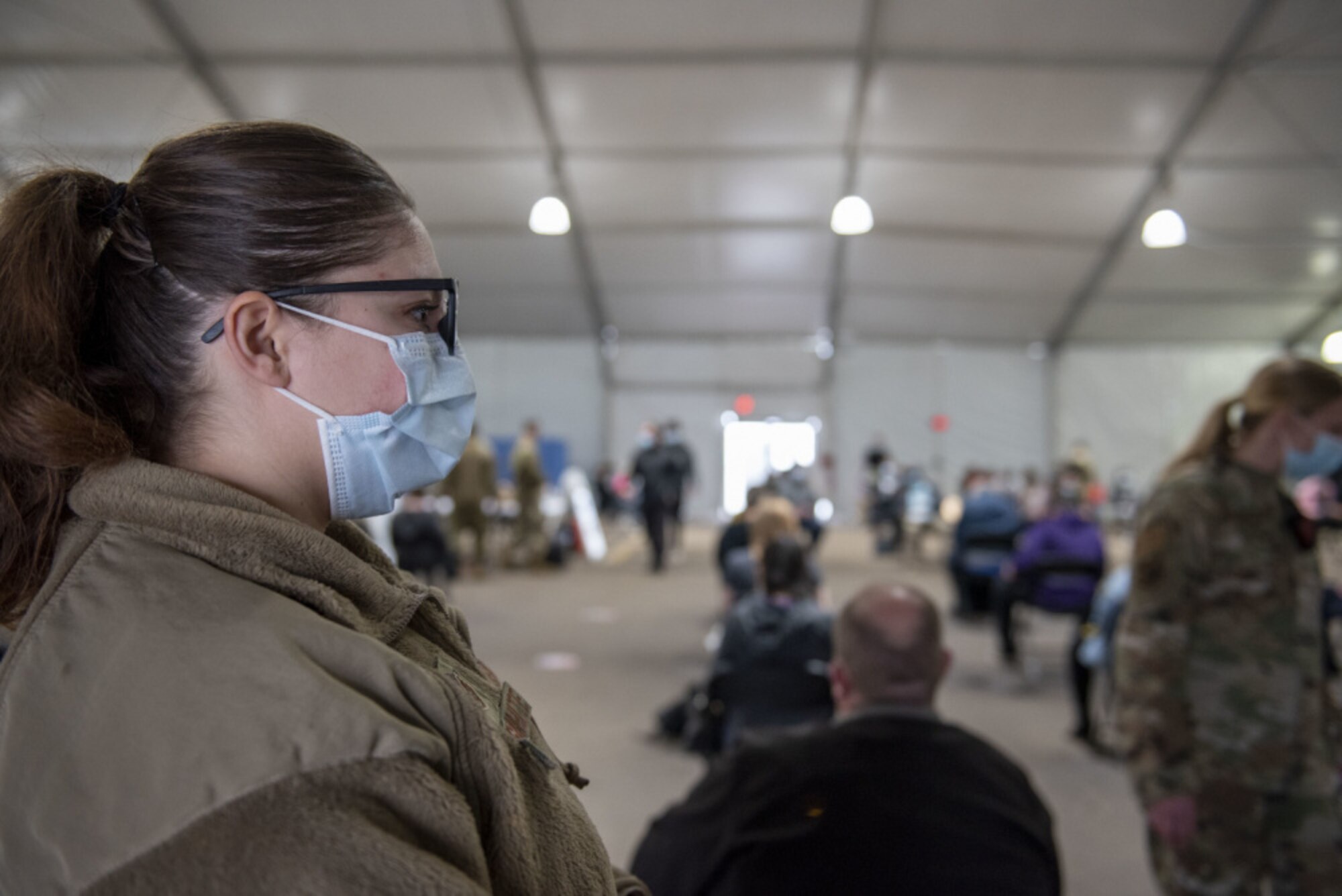 U.S. Air Force Staff Sgt. Tristan Crosswhite, assigned to the 92nd Operational Medical Readiness Squadron at Fairchild Air Force Base, Washington, observes local community members after receiving their COVID-19 vaccination at the Community Vaccination Center (CVC) at the Minnesota State Fairgrounds in St. Paul, Minnesota, April 23, 2021. The CVC welcomes St. Paul community members to receive free COVID-19 vaccines. U.S. Northern Command, through U.S. Army North, remains committed to providing continued, flexible Department of Defense support to the Federal Emergency Management Agency as part of the whole-of-government response to COVID-19. (U.S. Air Force photo by Staff Sgt. Mikaley Kline)