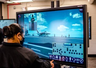 NORFOLK, Va. (May 14, 2021) A student at the Center for Naval Aviation Technical Training (CNATT) Unit Norfolk uses a Multipurpose Reconfigurable Training System (MRTS) 3D® system.  The MRTS 3D® Electromagnetic Aircraft Launch System (EMALS) provides high-fidelity operator and maintenance catapult system training for the U.S. Navy Ford-class aircraft carriers, which replicates the control room, generator room and flight deck crew using avatars. The MRTS 3D® EMALS simulation is a low-cost solution that includes both a lab and classroom.  (U.S. Navy photo)