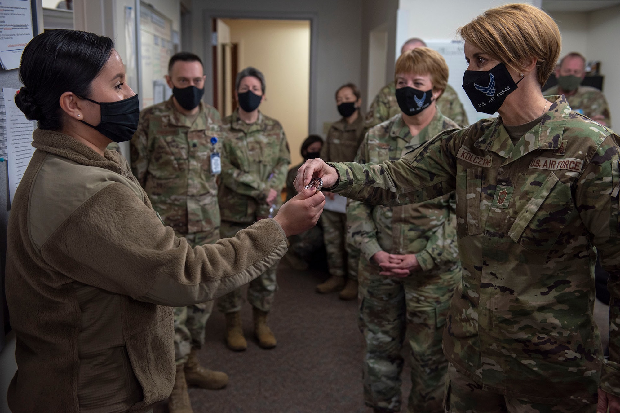 Chief Master Sgt. Dawn Kolczynski, medical enlisted force and enlisted corps chief, coins Tech. Sgt. Alejandra Allison, 341st Medical Group public health supervisor, for her work during the COVID-19 pandemic April 29, 2021, on her visit to Malmstrom Air Force Base, Mont.