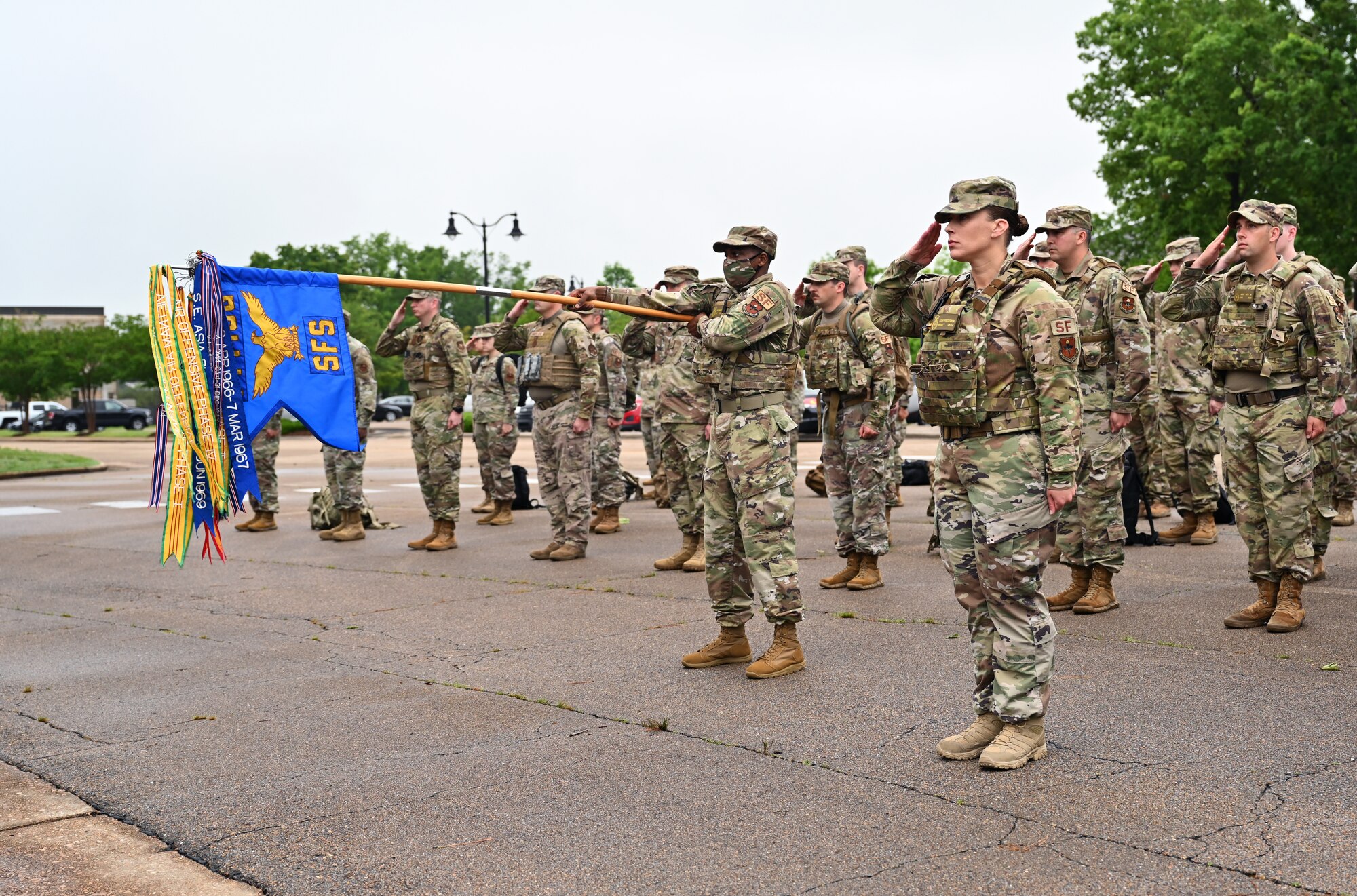 Squadrons from around the base salute the flag as reveille begins May 10, 2021, on Columbus Air Force Base, Mississippi. Reveille is a ceremony to signal the start of the duty day and shows respect to the flag along with Retreat used to signal the end of the duty day. (U.S. Air Force photo by Senior Airman Jake Jacobsen)
