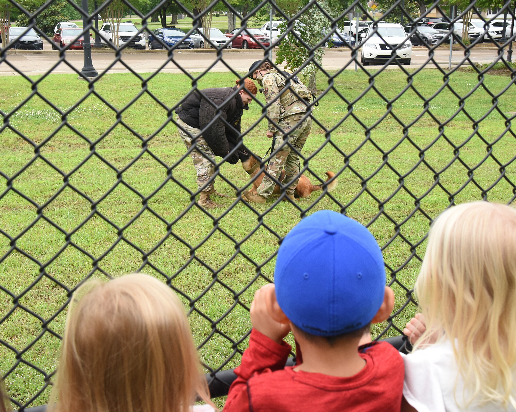 Children at the Child Development Center watch as Dixi, military working dog, and her handler showcase their skills, May 11, 2021, on Columbus Air Force Base, Mississippi. Working dogs are able to detect the scent of explosives, allowing for a more accurate and quick search of an area. (U.S. Air Force photo by Elizabeth Owens)