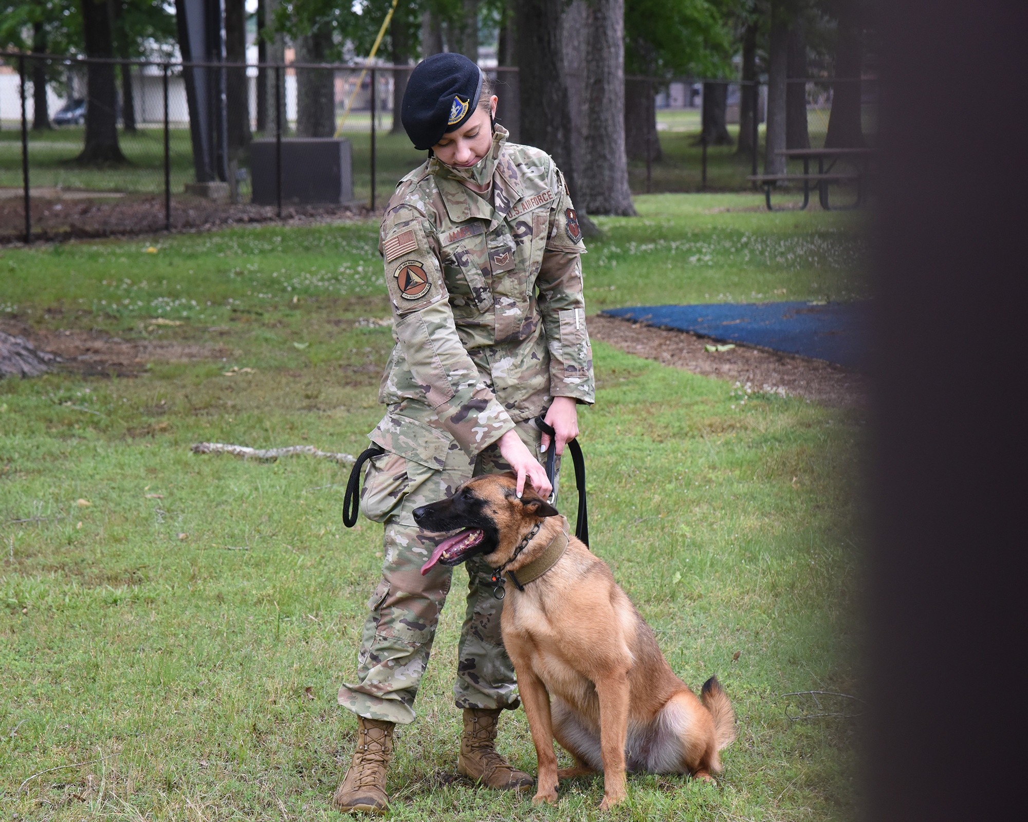 U.S. Air Force Staff Sgt. Amber James, 14th Security Forces Squadron Military Working Dog handler, stands with her partner, Dixi, before a demonstration, May 11, 2021, on Columbus Air Force Base, Mississippi. Military working dogs are deployed around the world to accomplish the Air Force mission by serving in a variety of roles such as tracking, search and rescue, or bomb detection. (U.S. Air Force photo by Elizabeth Owens)