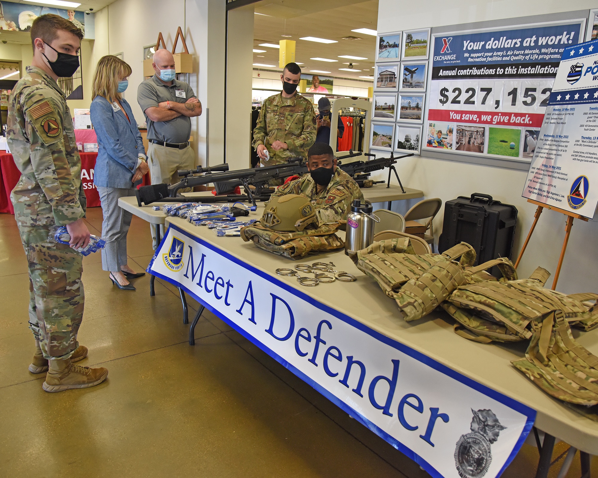 Airmen from the 14th Security Forces Squadron show the capabilities and requirements of their job to other Team Blaze members at a ‘Meet A Defender’ booth set up outside the Base Exchange, May 13, 2021, on Columbus Air Force Base, Mississippi. During National Police Week, security forces defenders and local law enforcement officers demonstrate their capabilities and daily responsibilities to the base and the public. (U.S. Air Force photo by Elizabeth Owens)
