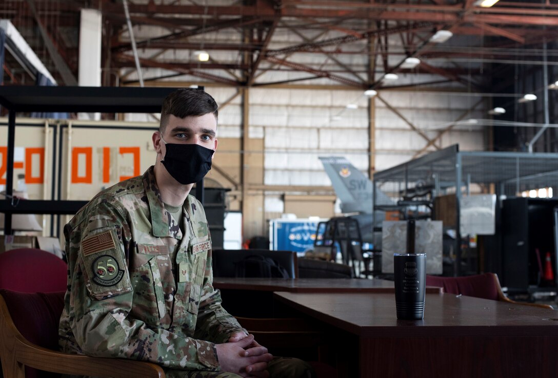 A photo of SrA Connor Watts posing in a hangar.