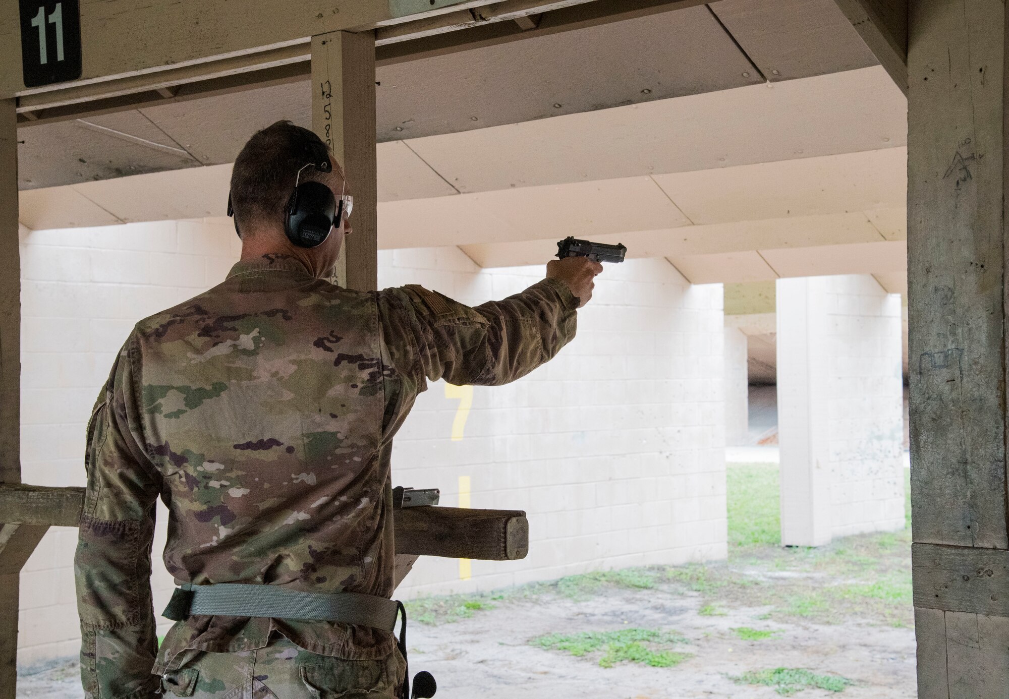 Col. Jason Loschinskey, 6th Mission Support Group commander, fires his weapon during an inaugural Excellence in Shooting Competition event during Police Week at MacDill Air Force Base, Florida, May 13, 2021.