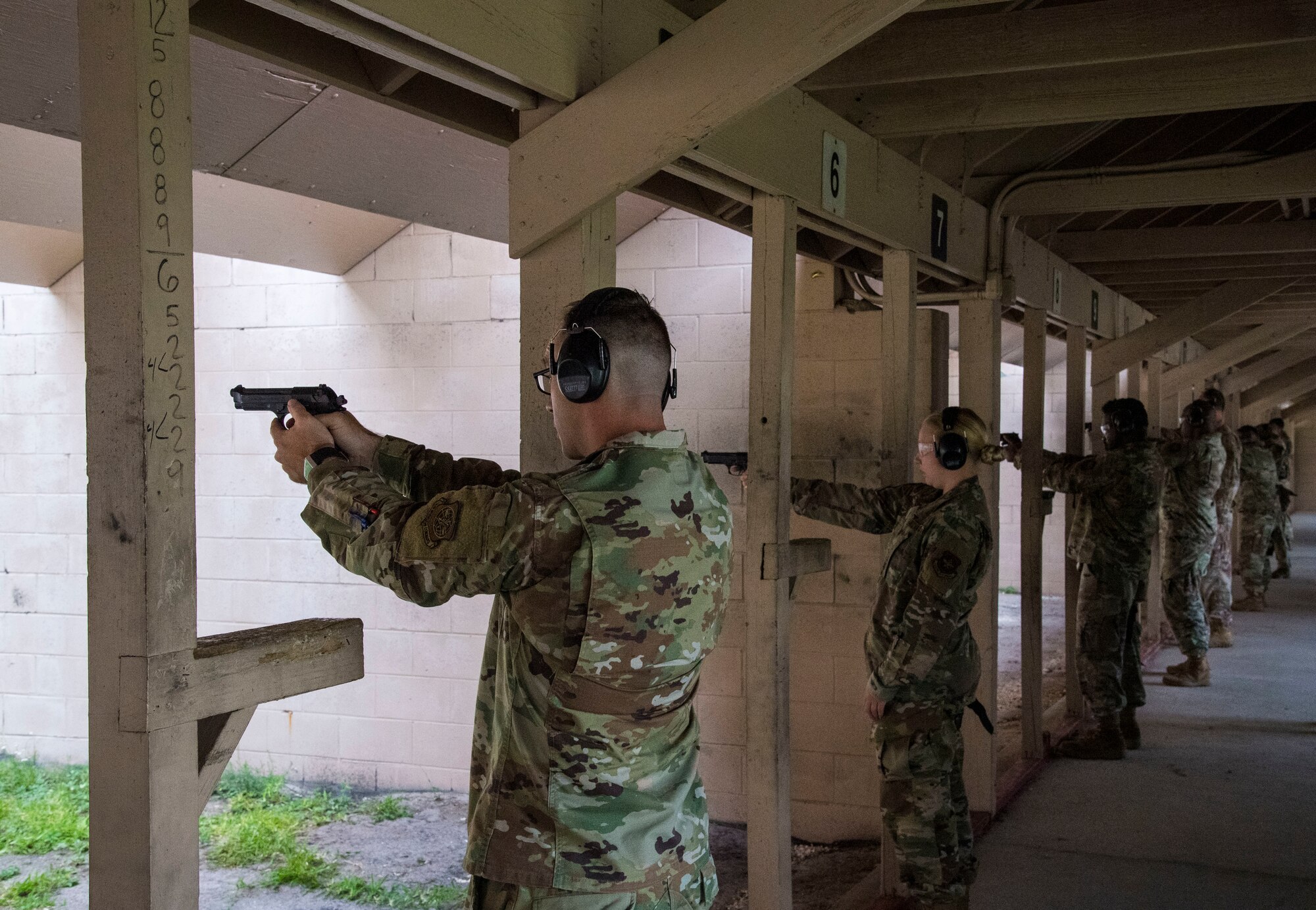 Chief Master Sgt. Timothy Bayes, the 6th Mission Support Group superintendent, fires his weapon during an inaugural Air Force Excellence in Shooting Competition event alongside a group of Airmen at MacDill Air Force Base, Florida, May 13, 2021.