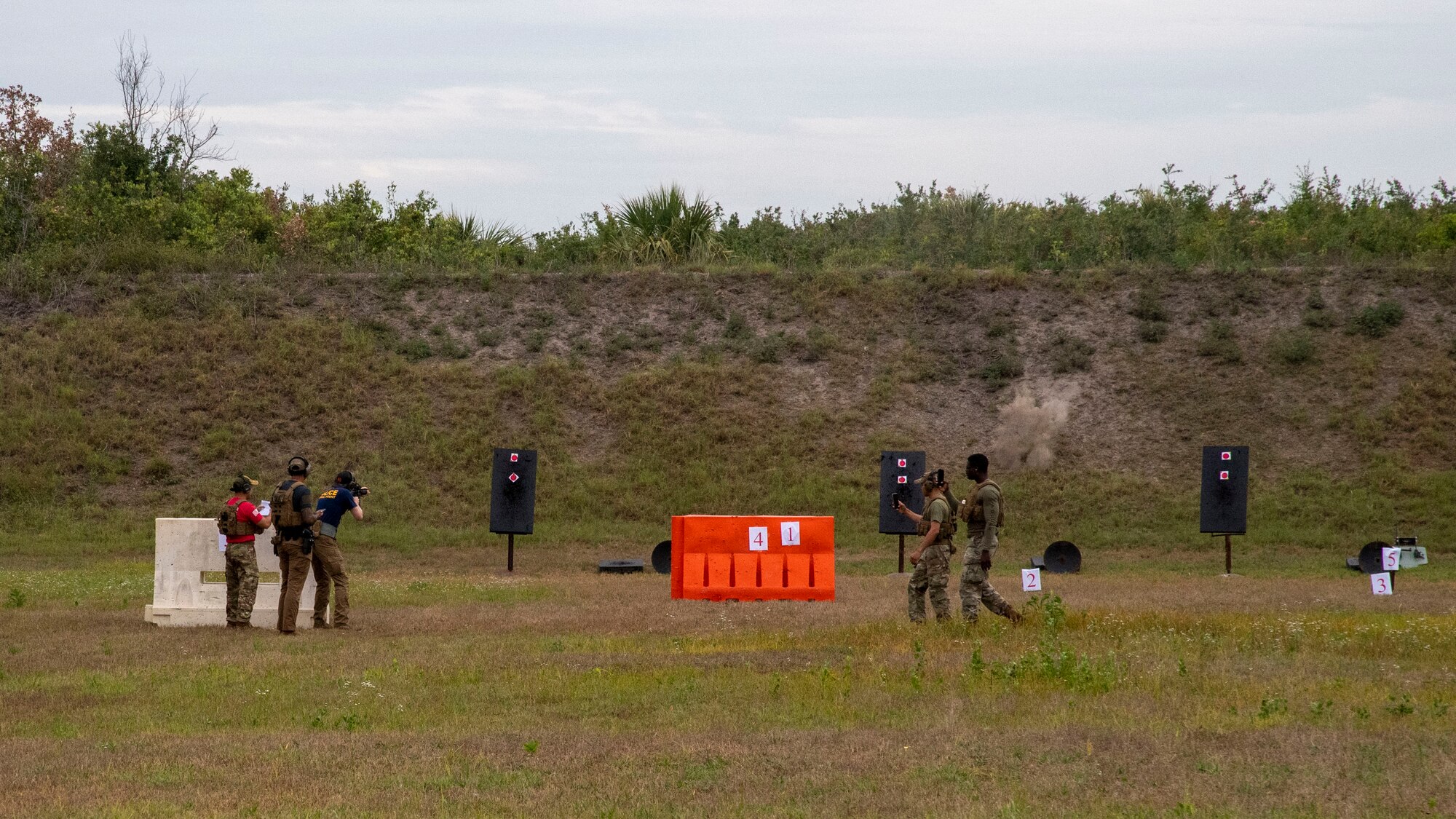 An Air Force Office of Special Investigations (OSI) special agent alongside a group of Airmen from the 6th Security Forces Squadron (SFS) compete at the inaugural individual firearms shooting competition at MacDill Air Force Base, Florida, May 13, 2021.