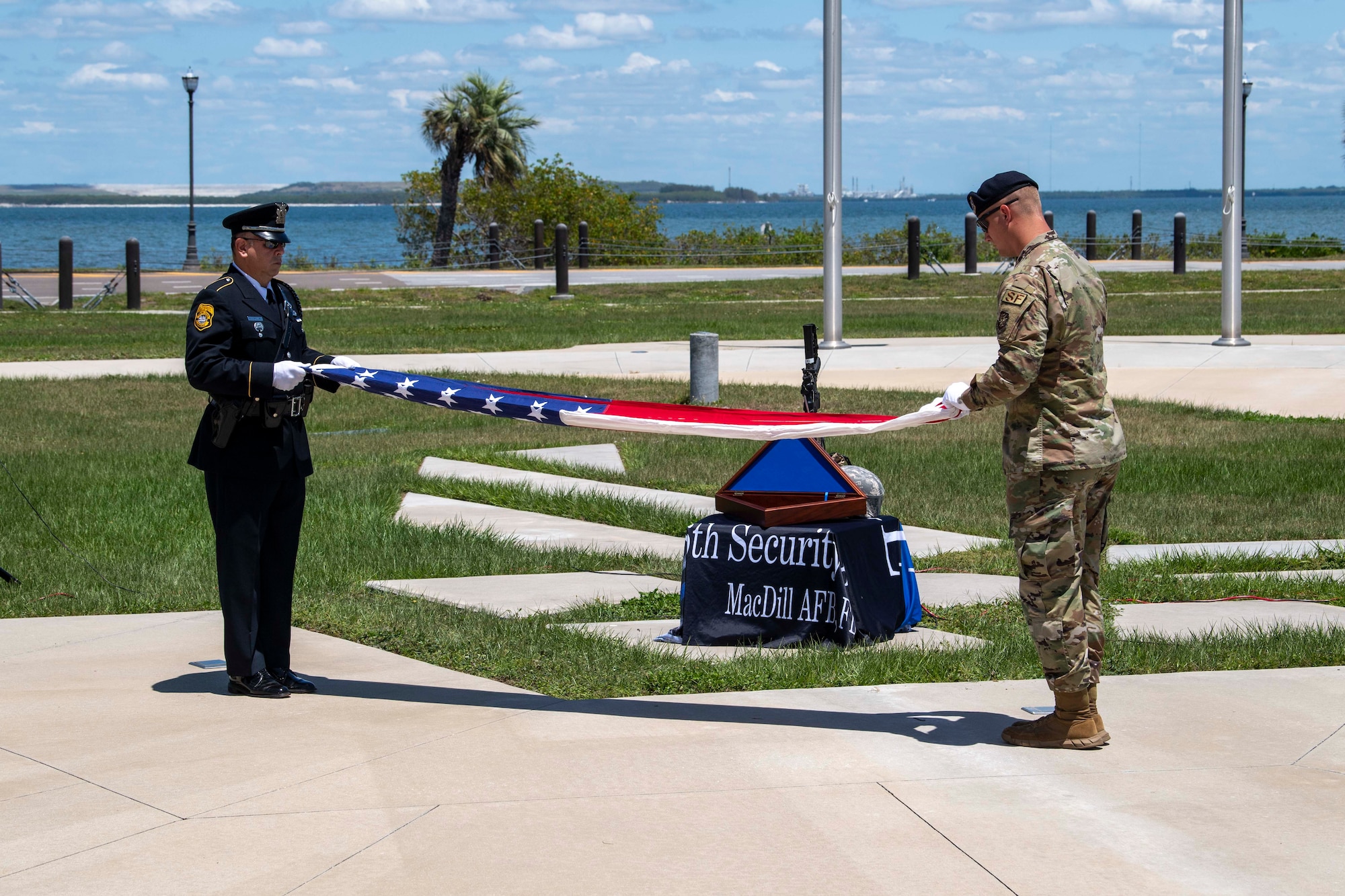 A U.S. Flag is folded and placed next to a Fallen Soldier Battle Cross at MacDill Air Force Base, Florida, May 14, 2021.
