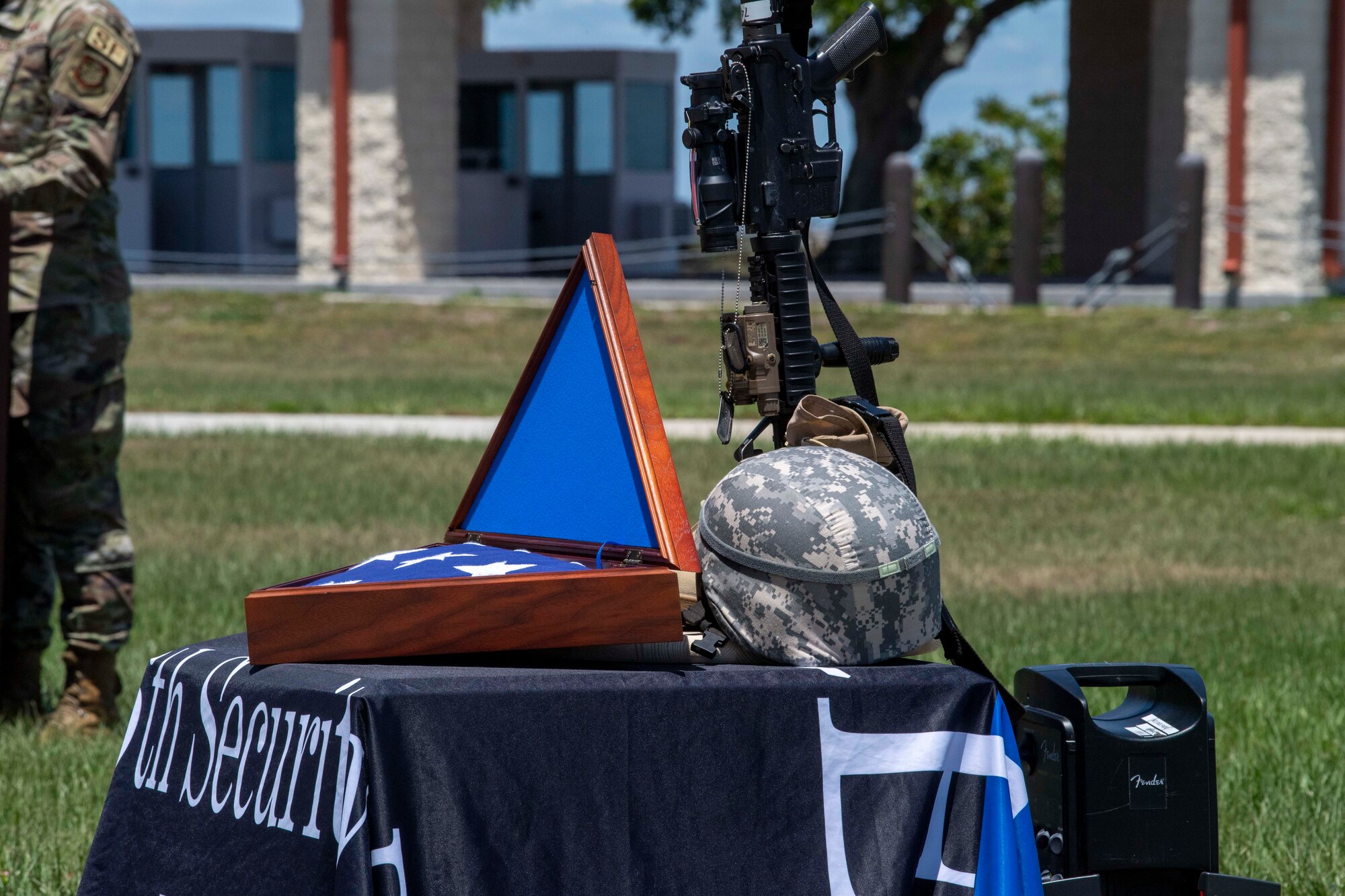 A City of Tampa Police Department Honor Guardsmen (left), and an Airman with the 6th Security Forces Squadron (SFS) fold the flag during a ceremony at MacDill Air Force Base, Florida, May 14, 2021.