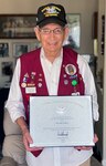 Victor Lopez holds the President's Volunteer Service Award, awarded to him at the JBSA Volunteer of the Year Awards ceremony April 21.