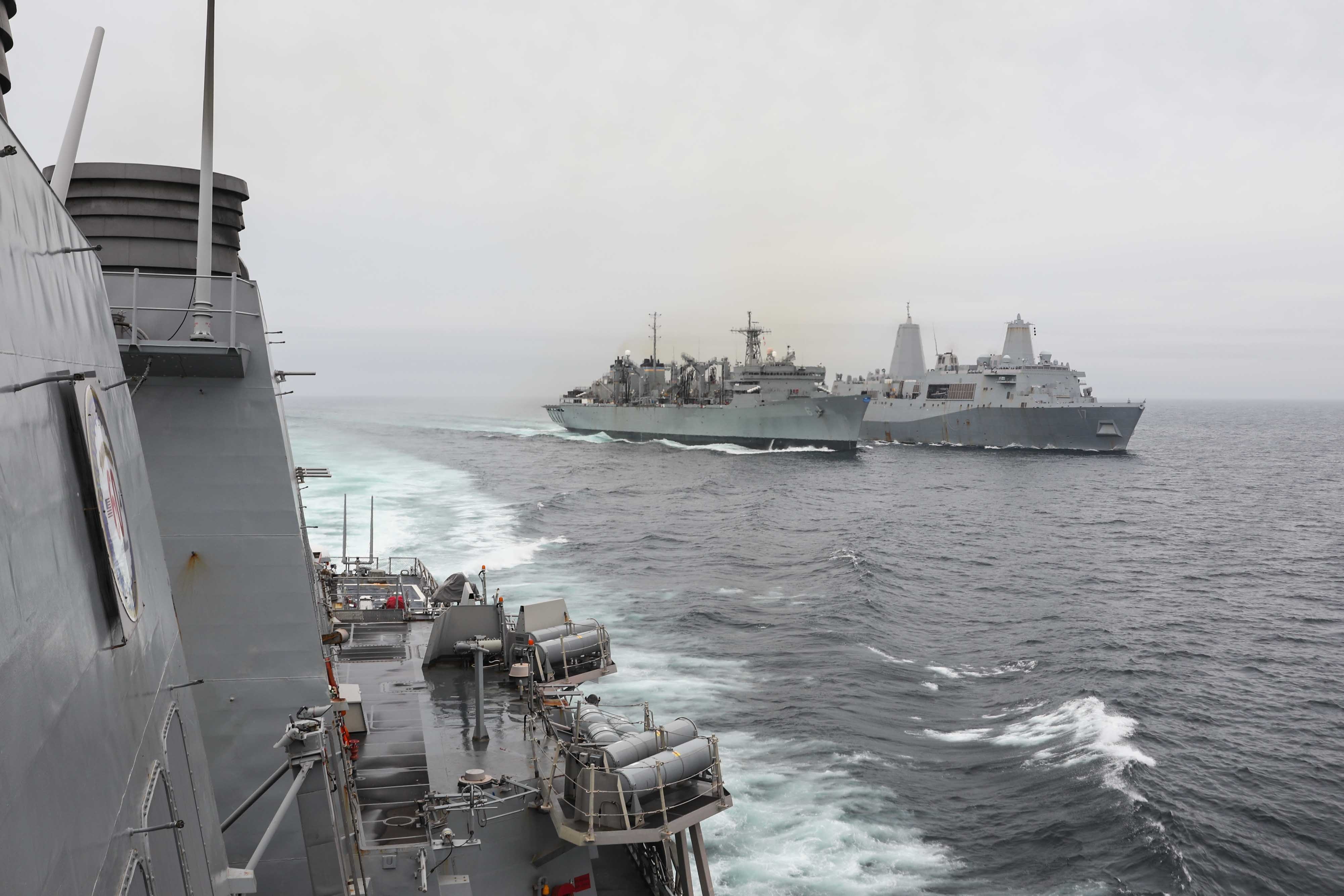 The Arleigh Burke-class guided-missile destroyer USS Ross (DDG 71), left, breaks away from the fast combat support ship USNS Supply (T-AOE 6) and the amphibious transport dock ship USS San Antonio (LPD 17) following a replenishment-at-sea.