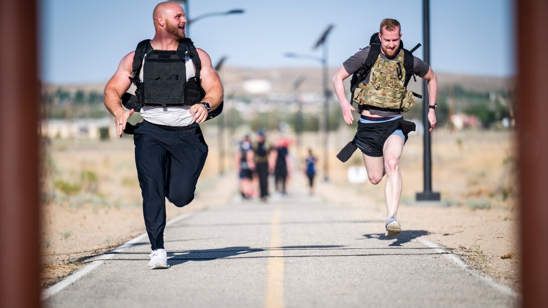 Senior Airman Douglas Ryan and Staff Sgt. Jake Harris, both of the 412th Security Forces Squadron race to the finish line during the Annual Police Week Run/Ruck/Walk Event at Edwards Air Force Base, California, May 10. (Air Force photo by Giancarlo Casem)