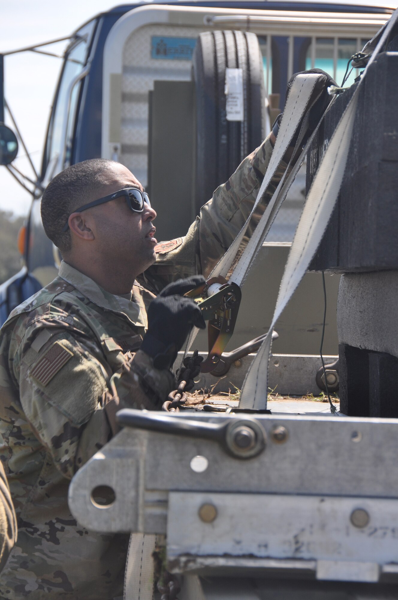 a man securing cargo on a truck