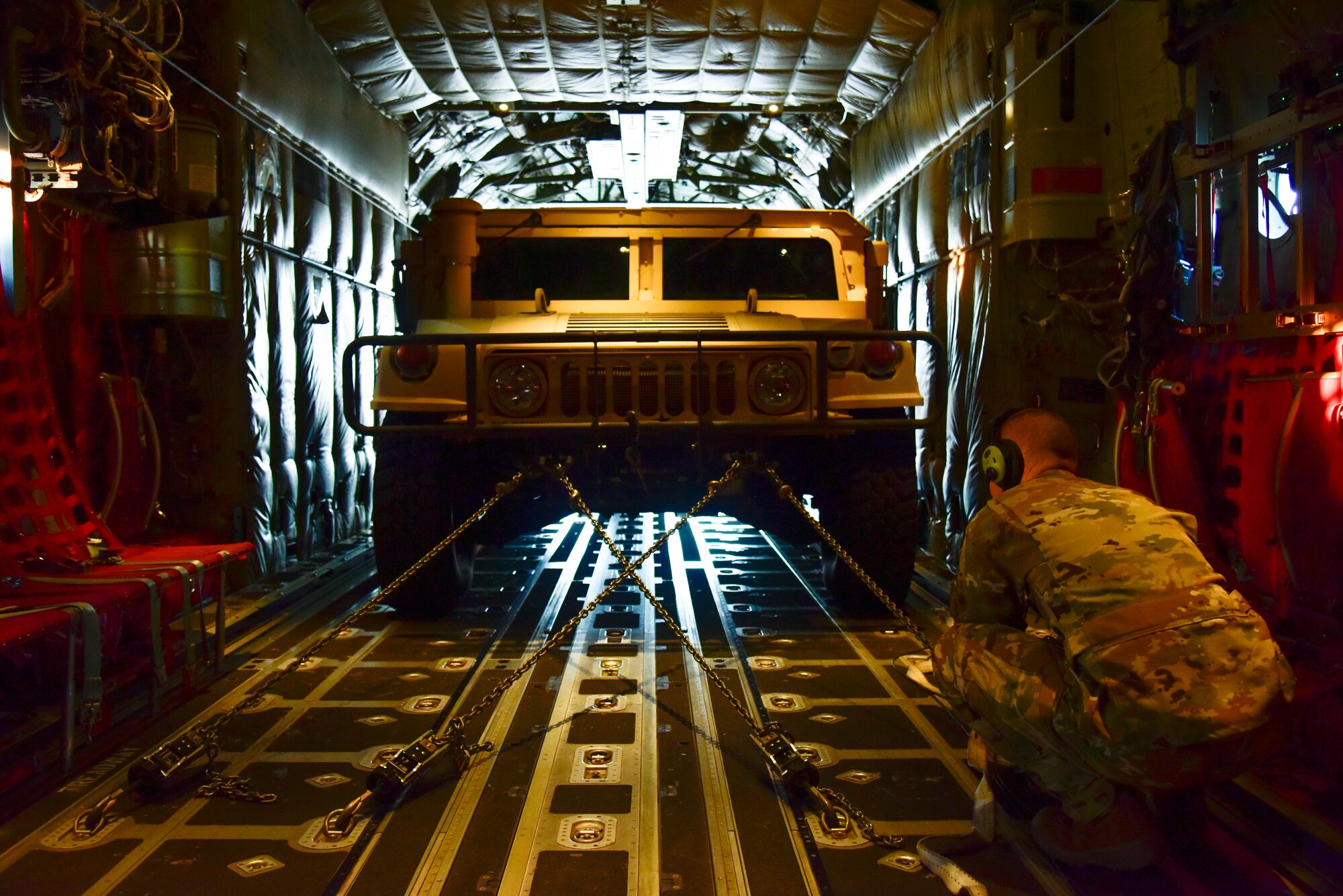 U.S. Air Force Reserve Senior Airman Richard Brewster, 327th Airlift Squadron loadmaster, secures a Humvee in the cargo area of a C-130J Super Hercules at an airport near Salina, Kansas, May 12, 2021. The Air Force Reserve 327th Airlift Squadron provided agile combat support and cargo handling training opportunities to the 442d Fighter Wing's training event. (U.S. Air Force photo by Senior Airman Kalee Sexton)