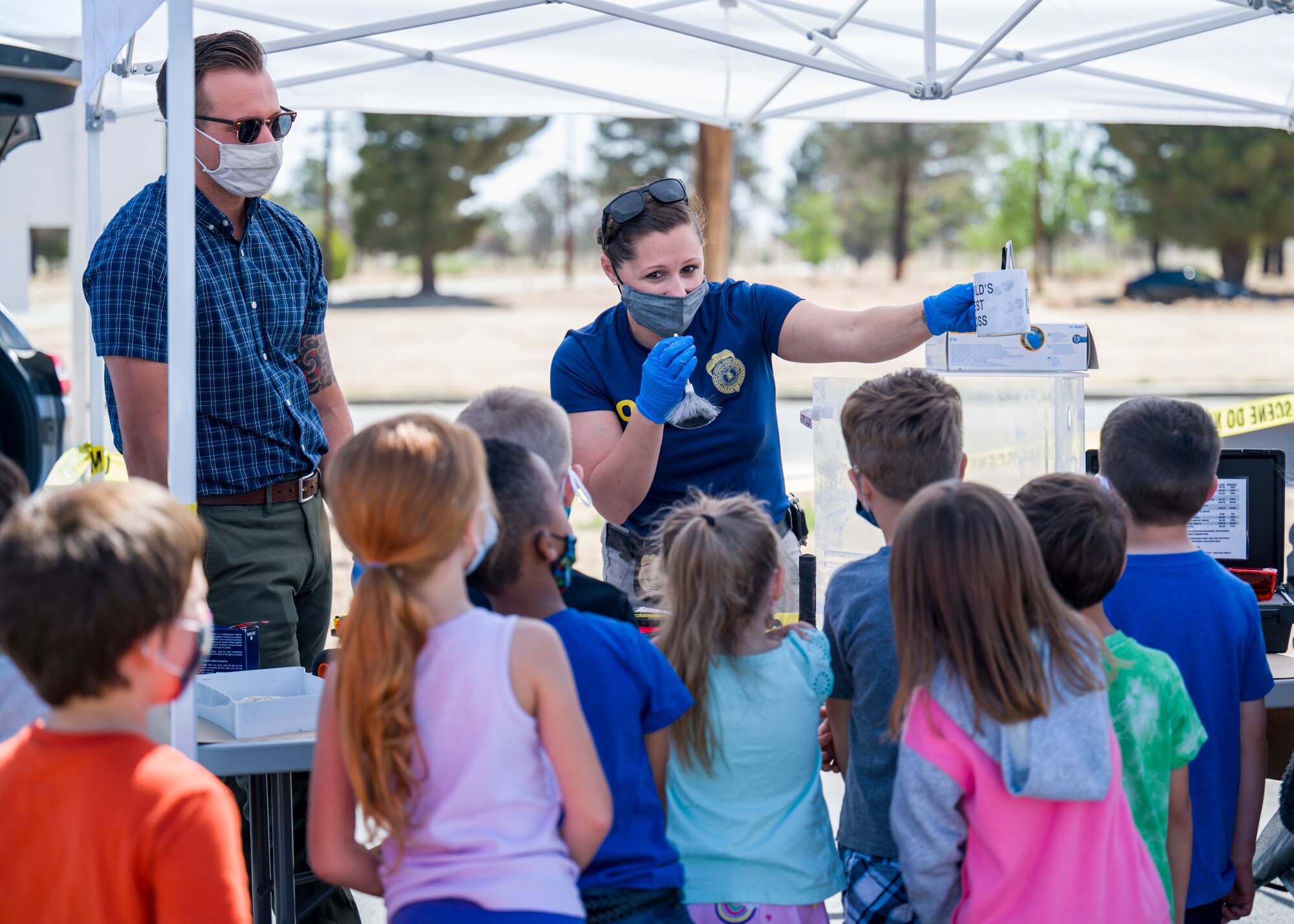 Office of Special Investigations agents show Bailey Elementary School students how they obtain fingerprints during Police Week 2021 at Edwards Air Force Base, California, May 11. (Air Force photo by Giancarlo Casem)
