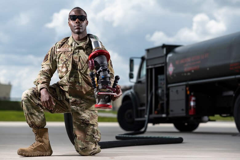 Portrait of Airman in front of fuels truck.