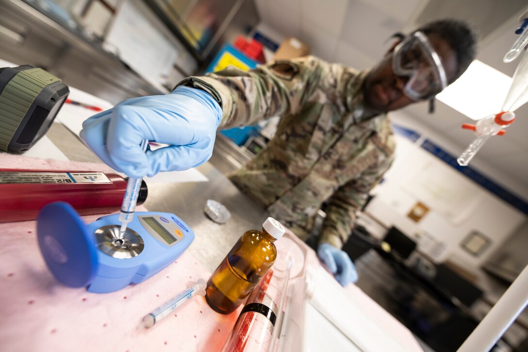 U.S. Air Force fuels laboratory technician Airman tests fuel quality in the laboratory.