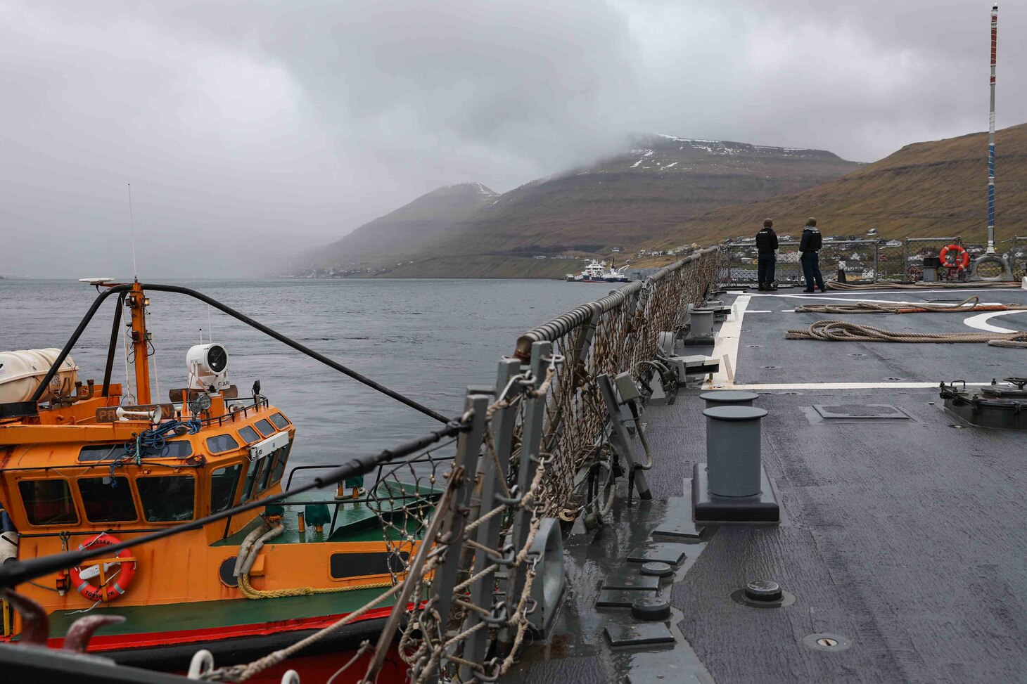 Sailors stationed aboard the Arleigh Burke-class guided-missile destroyer USS Ross (DDG 71) lower an accomodation ladder to the pier in port in the Faroe Islands, May 15, 2021.