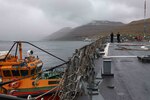 Sailors stationed aboard the Arleigh Burke-class guided-missile destroyer USS Ross (DDG 71) hold a phone and distance line during a replenishment-at-sea with the fast combat support ship USNS Supply (T-AOE 6), May 10, 2021.