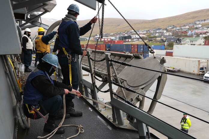 Sailors stationed aboard the Arleigh Burke-class guided-missile destroyer USS Ross (DDG 71) lower an accomodation ladder to the pier in port in the Faroe Islands, May 15, 2021.