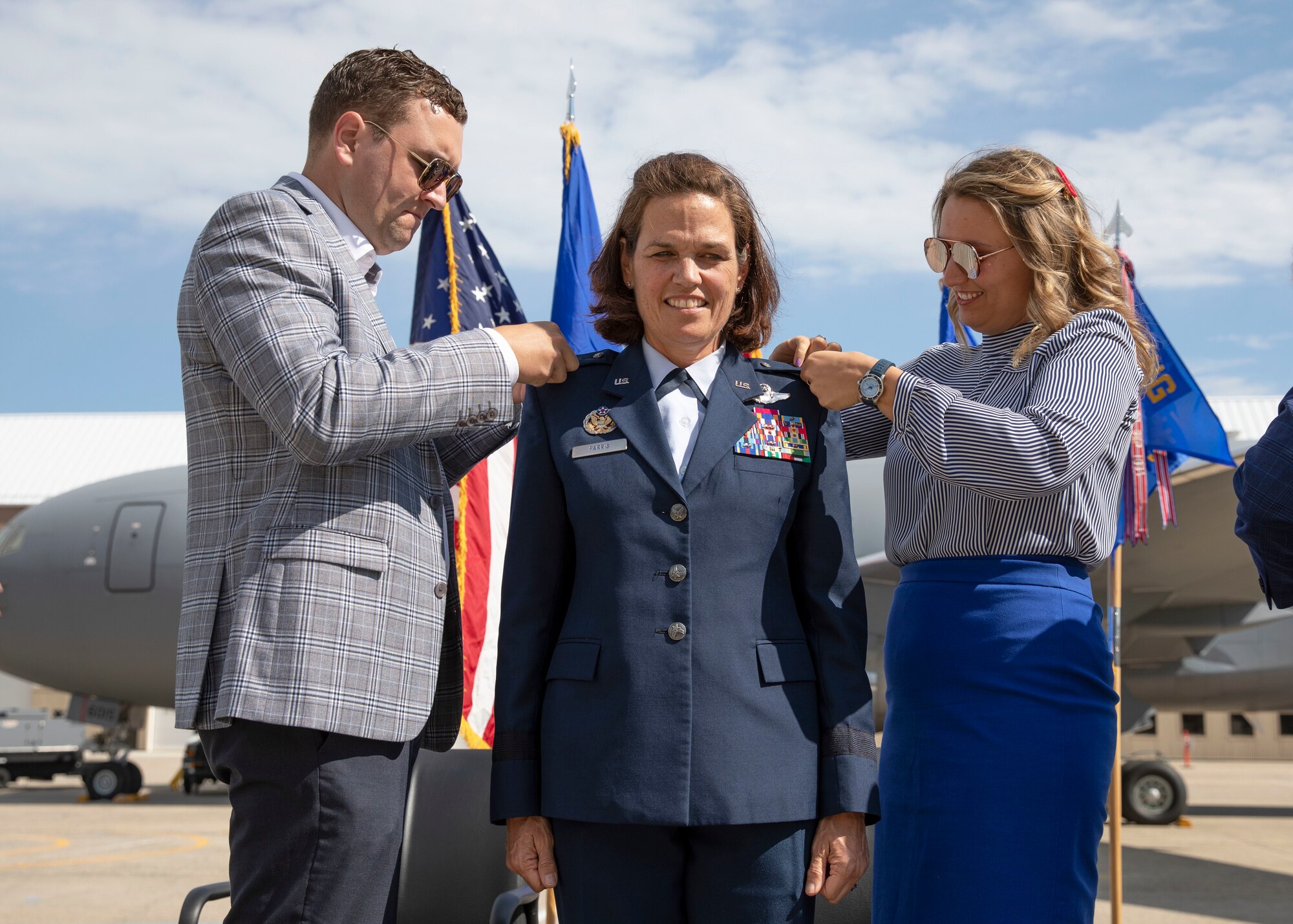 Newly promoted Maj. Gen. Laurie Farris' children, Drew and Taylor, pin stars to her uniform at a promotion ceremony held May 15 at Pease Air National Guard Base. Farris is assuming a position as the assistant to the commander of Air Mobility Command, Scott Air Force Base, Ill. Photo by Staff Sgt. Charles Johnston, NHNG Deputy State PAO.