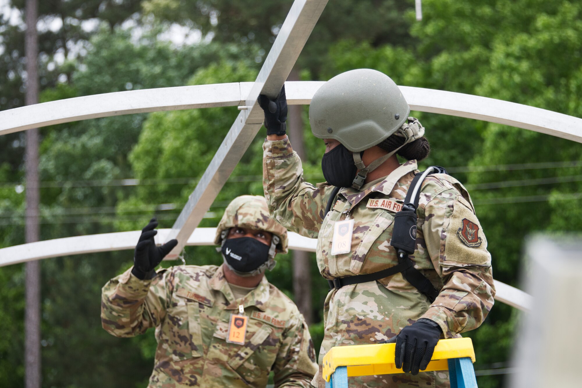 Photo of Airmen building a tent