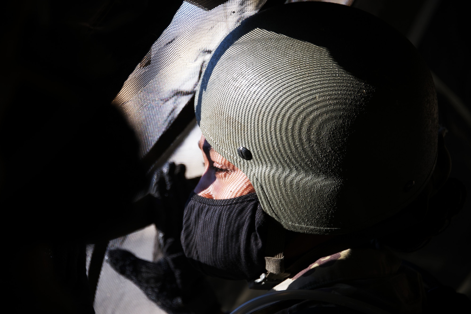 Photo of Airman staring out window.