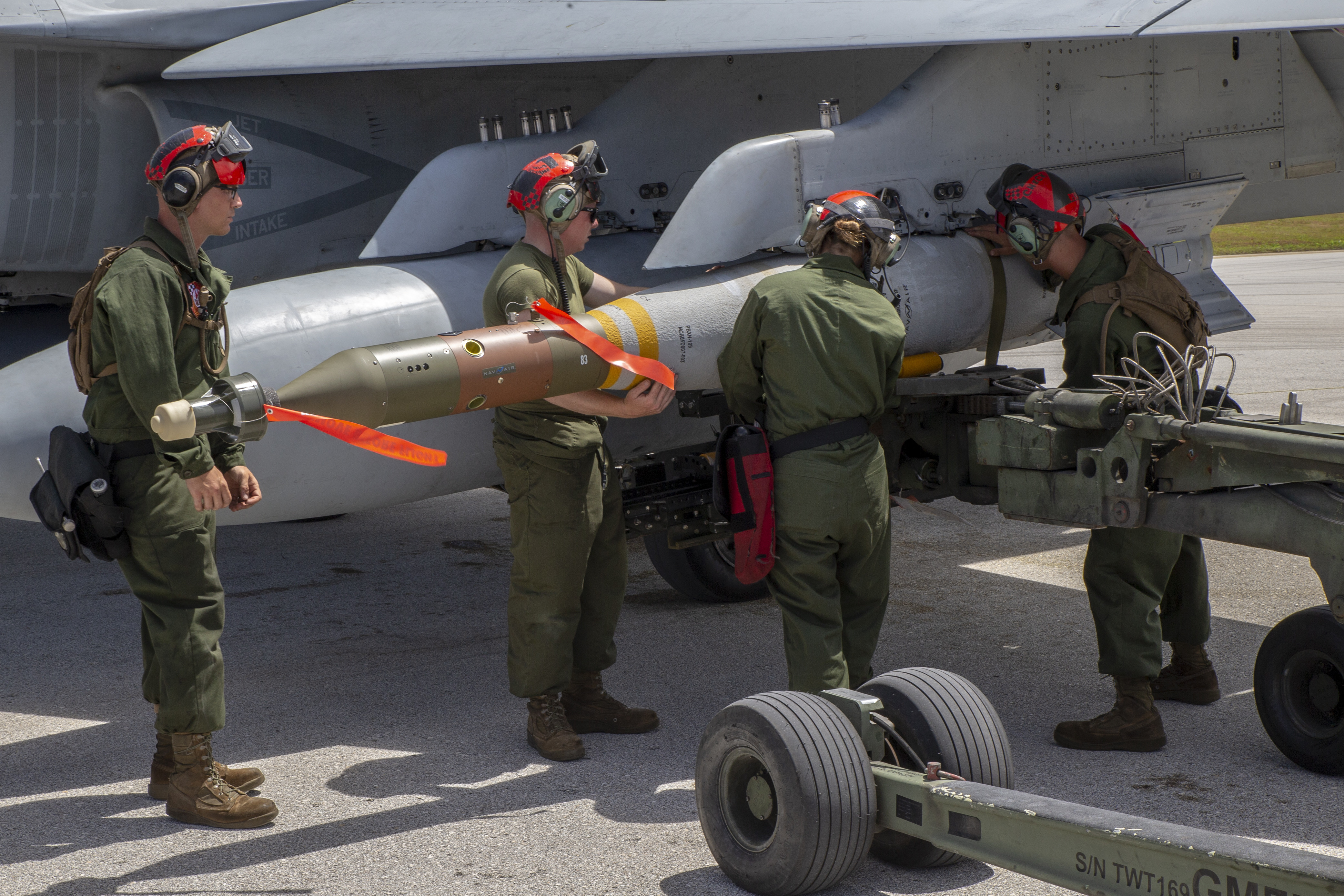 Ordnance Technicians assigned to Marine Fighter Attack Squadron (VMFA) 312 load live ordnance as part of unit level training in Guam, March 2, 2021.