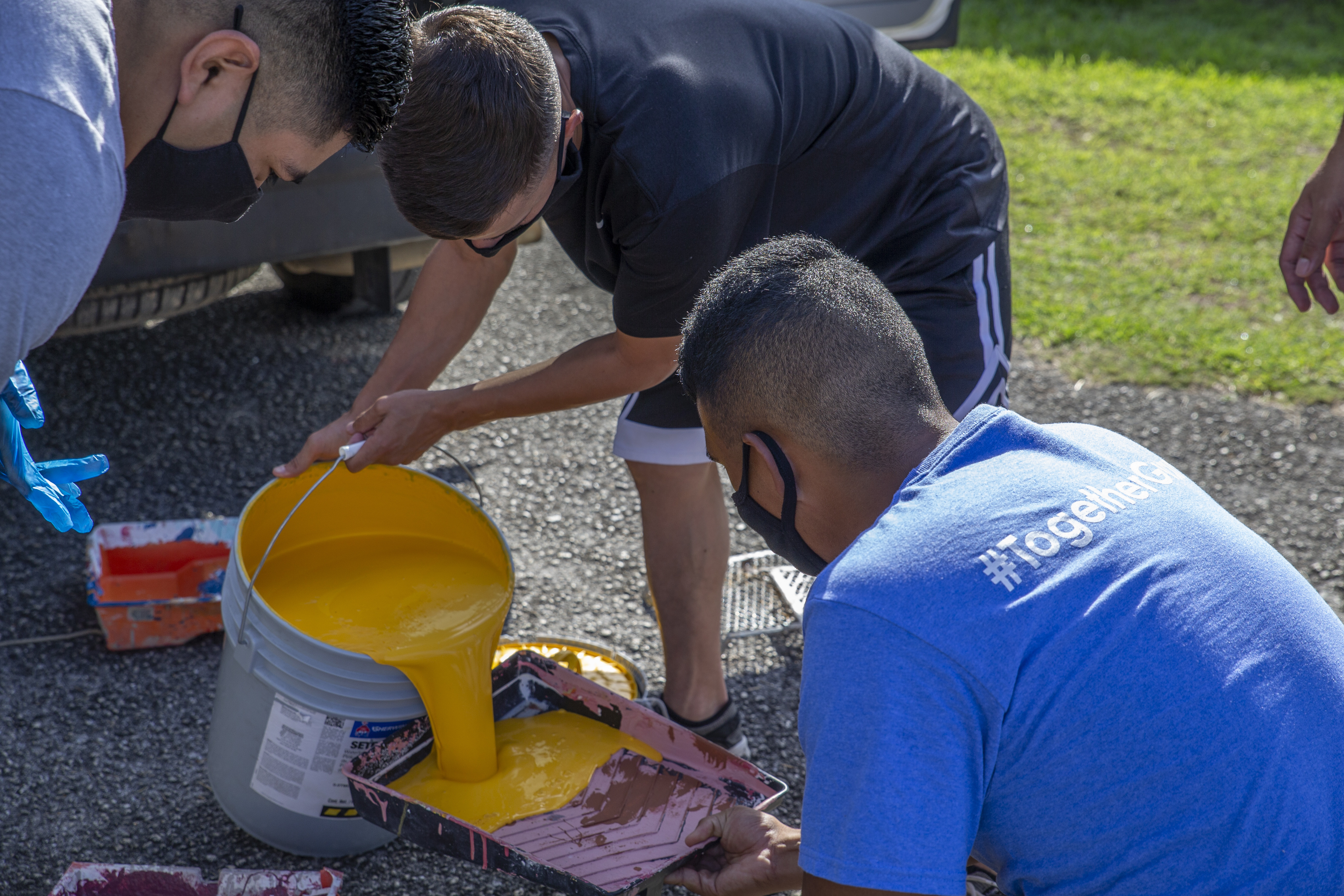 U.S. Marines assigned to Marine Corps Base (MCB) Camp Blaz pour paint in preparation of a volunteer with employees of the Barrigada Mayor’s Office in Barrigada, Guam, April 8, 2021.