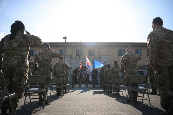 Airmen salute during a Police Week ceremony.