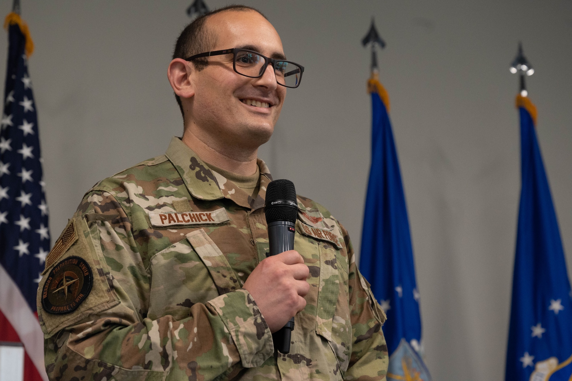 An Airman speaks at a ceremony.